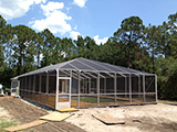 Freestanding pool enclosure with hip gable roof by East Coast Aluminum