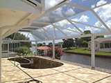 Mansard style pool enclosure with picture view walls by East Coast Aluminum